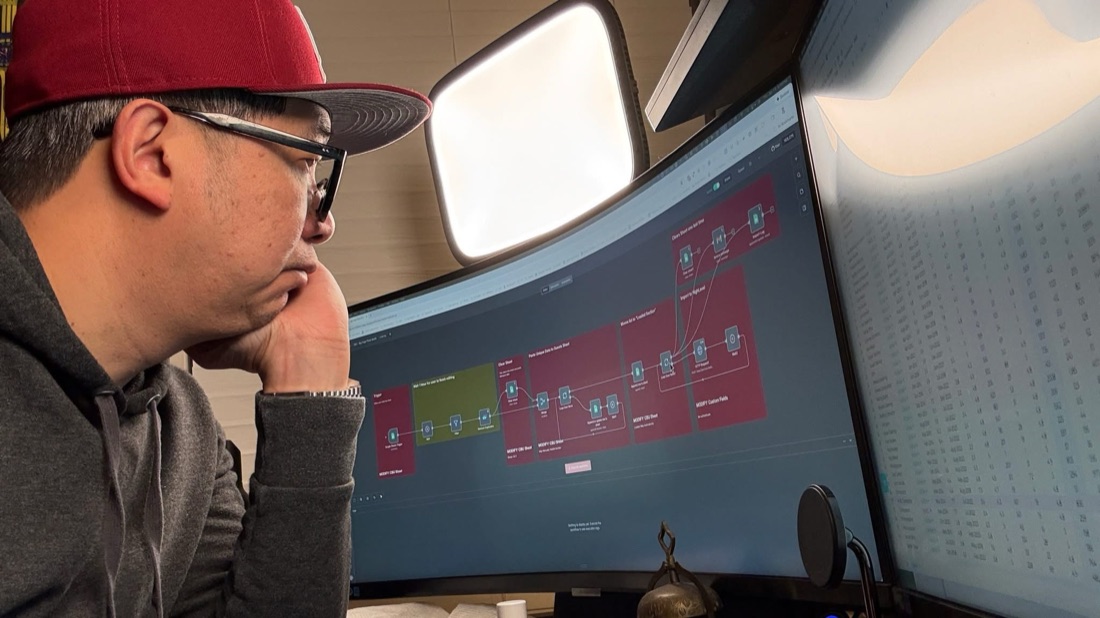 Rengie Mendoza building an automation workflow at his computer